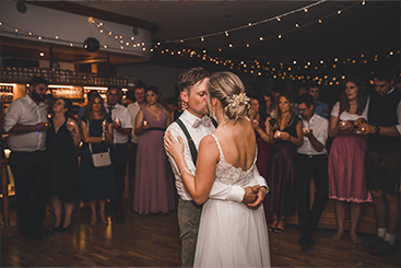Eine Braut und ein Bräutigam genießen ihren ersten Tanz bei ihren Hochzeitsfeiern.
